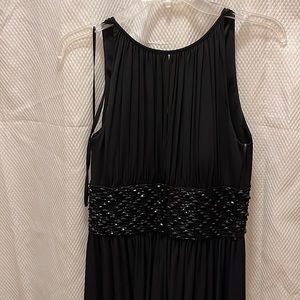Black floor dress with black beads .